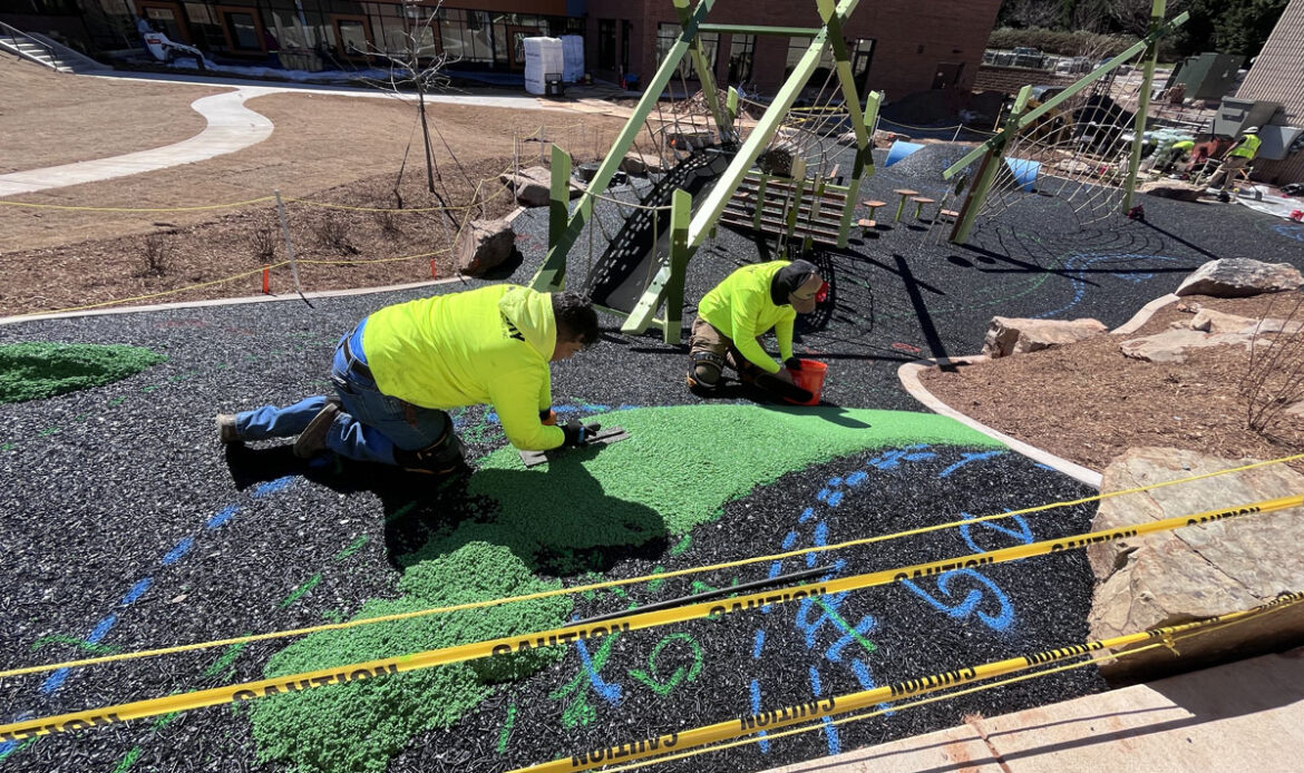 Replay Surfacing USA team laying poured in place rubber surface for playground safety and outdoor durability