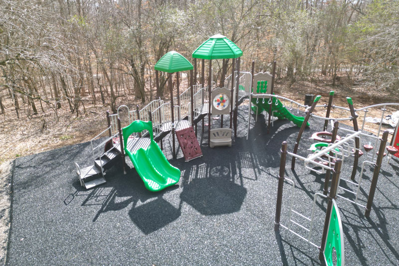 Experienced surfacing contractor installing poured-in-place rubber surfacing in Austin on a renovated public playground, featuring slip-resistant and shock-absorbing rubber mulch designed for Texas climates. This custom rubber paving project by a trusted surfacing company in Austin delivers durable, low-maintenance playground surfaces and residential pool decks that comply with national safety standards.
