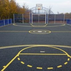 Installation of custom sport surfacing on a basketball playground, demonstrating outdoor sports surfaces and safeplay sports surfaces designed to enhance safety, traction, and durability for athletic facilities across the United States of America.