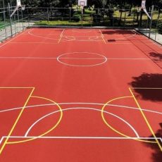Outdoor basketball playground featuring custom sport surfacing and safeplay sports surfaces designed for durability and safety. This sport court surface installation in the United States of America highlights advanced sports surfacing solutions for superior athletic performance."