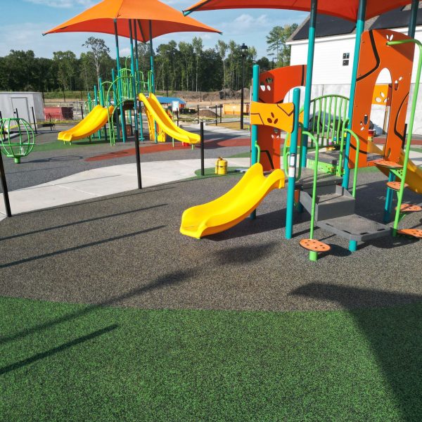 Rubber surfacing work for kids playground splash pads in the United States, showcasing versatile splash pad rubber surfacing options with vibrant colors and patterns. This durable, slip-resistant splash pad surface enhances safety and aesthetics, ideal for Charlotte splash pads and customizable splash pad surfaces that combine fun, comfort, and long-lasting performance.