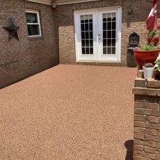 Residential rubber surfacing installation outside a modern home in the United States, showcasing a safe, slip-resistant rubber playground surface ideal for driveways, patios, and pool decks. Replay Rubber Surfacing offers durable, low-maintenance, and eco-friendly residential rubber surfacing solutions across the USA.