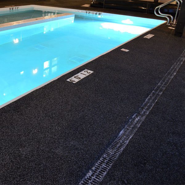 Beautiful residential swimming pool area featuring premium rubber playground surface, installed by Replay Rubber Surfacing in the United States. This safe, slip-resistant residential rubber surfacing enhances outdoor spaces with durability, style, and comfort—perfect for families seeking long-lasting and eco-friendly poolside solutions for their homes across the USA.